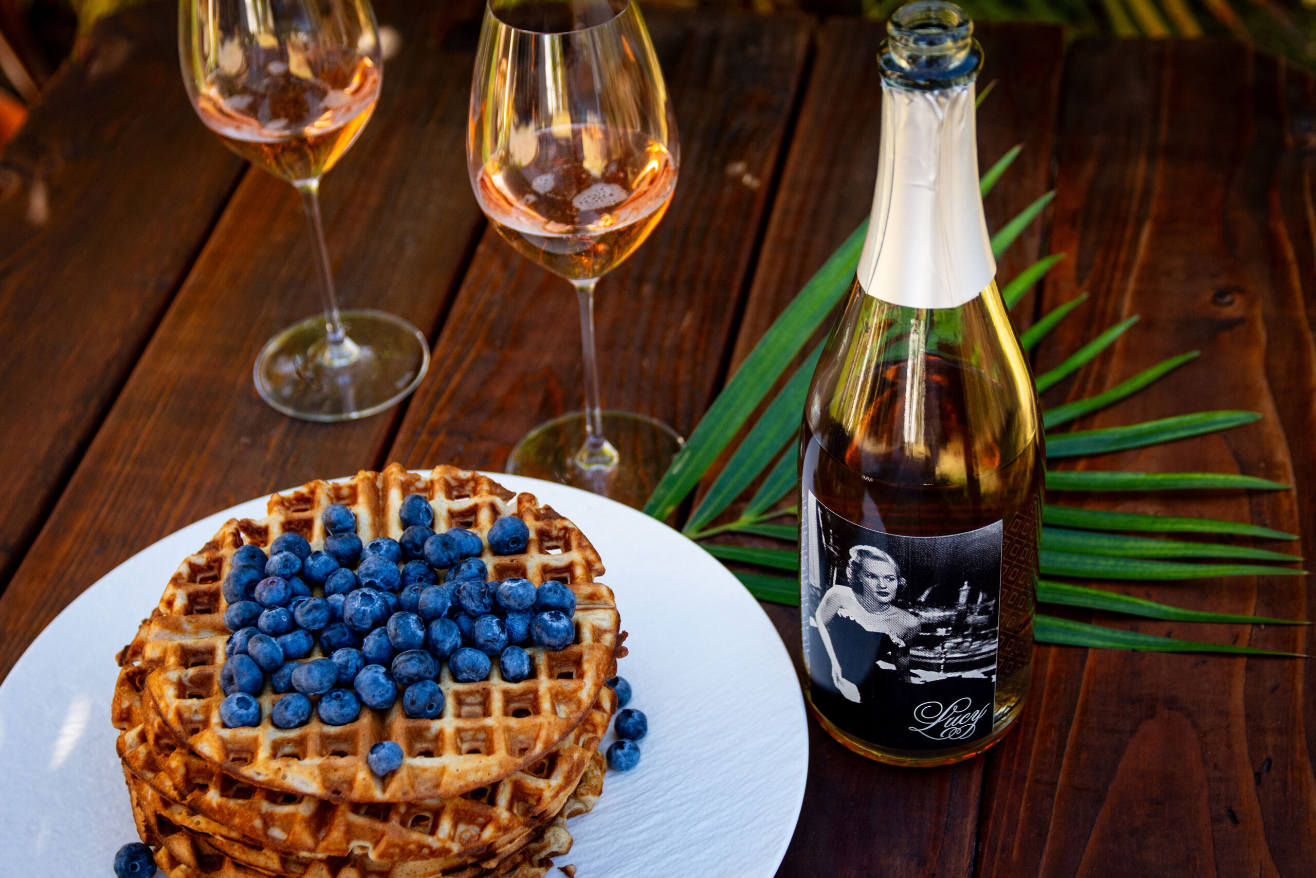 Waffles with blueberries and a bottle of Lucy